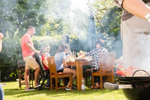 Personen beim Grillen im Garten